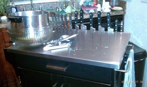 Knives on magnetic holder on kitchen island, from the workside.